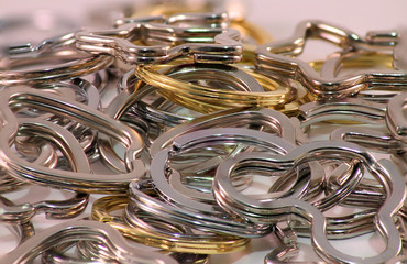 Macro photo of various types of curly rings lying in a common heap.