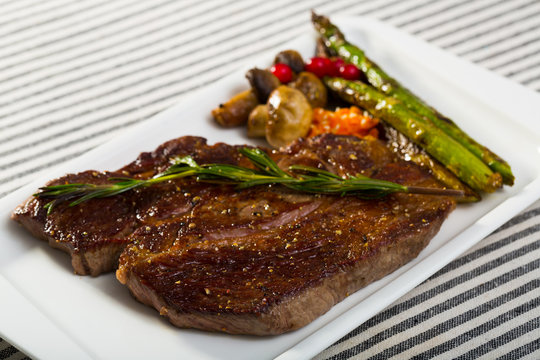 Photography of plate with beef entrecote with mushroom and asparagus