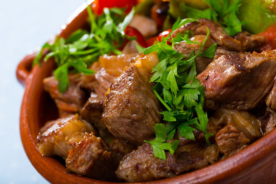 Cooked gyuvech dish of bulgarian cuisine of beef  with vegetables at clay pot