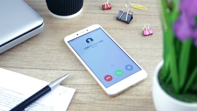 Phone call, incoming call on the mobile phone. Phone on the table