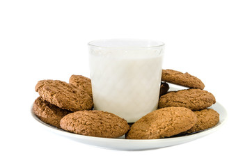 oatmeal cookies in a plate and a glass of milk on a white background. Side view.