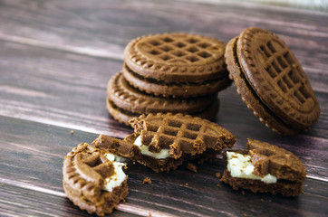 sandwich cookies on a wooden table. Close-up.