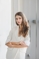 Businesswoman posing near windows..