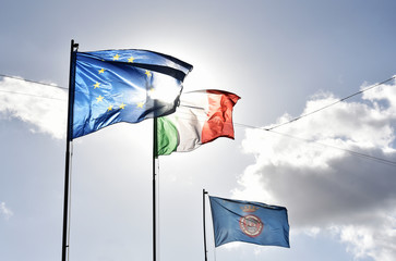European flag, italian flag and Nemi's flag waving together in a clear sky. Relationship between...