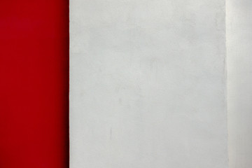 Two colors wall background. Red and light gray plaster wall backdrop