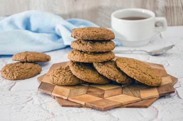 oatmeal cookies and a cup of tea on the kitchen table. Morning tea party.