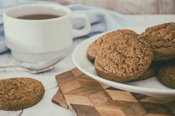 oatmeal cookies and a cup of tea on the kitchen table. Morning tea party.