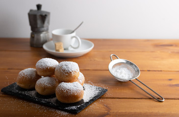 Carnival italian deep fried fritters with sugar icing,Homemade deep fried sweet fritters covered with sugar on a white background
