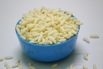 Puffed rice on the blue bowl with white background