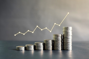 Stack of Thailand coins on black wooden table with profit graph, growth up, success. Business, finance, marketing, e-commerce concept and design