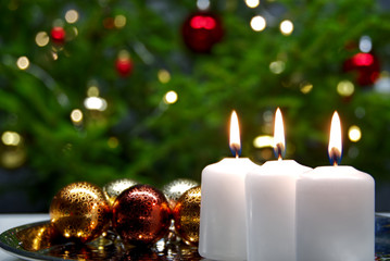 three burning candles with Christmas decoration. xmas composition.
