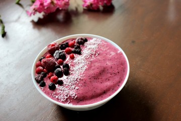 Pink smoothie bowl red fruits