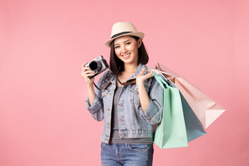 Tourist woman in summer casual clothes.Asian Smiling woman .Passenger traveling abroad to travel on pink background.She going to summer vacation.Travel trip funny Credit card on holiday.