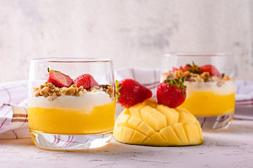 cream cheese with mango, baked oatmeal and strawberries on pink background