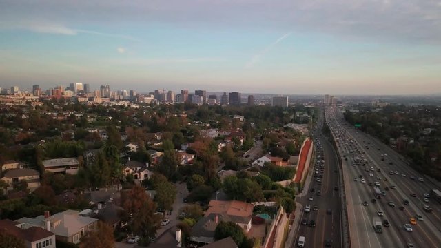 Aerial Of Urban Wilshire Corridor With Westwood And Freeway In West LA During Rush Hour. 4K