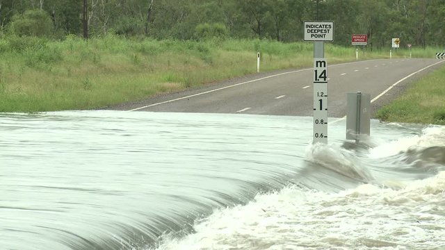 Flash Flood Flows Over Road With Depth Markers - Carlos