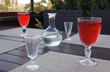 the decanter of vodka and shot glasses on the table in street cafe
