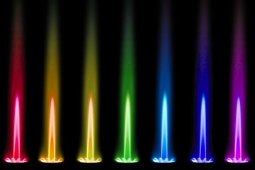 The flame of a gas burner shines like a rainbow in the dark
