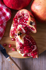 natural open pomegranate fruit on wood