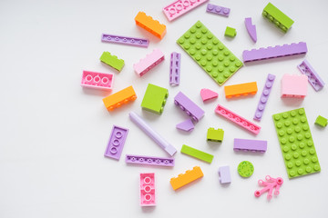 Multicolored plastic building blocks of the designer. plastic colored details building blocks. Parts of bright small spare parts for toys. Preschooler at home or daycare, preschool. Kindergarten