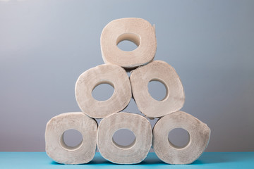 Rolls of soft toilet paper  are stacked by a pyramid
