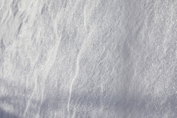 Obraz premium The texture of the snow. Winter rainfall. Tracks on a snowy road after a snowfall.