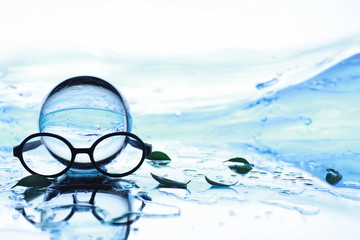 Tools for vision correction. Glasses and lenses with diopters on the background of splashes and...