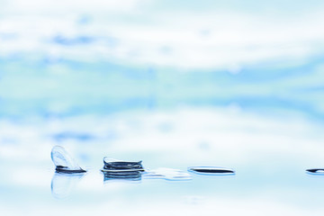 Tools for vision correction. Glasses and lenses with diopters on the background of splashes and...