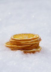 Merry Christmas and  New Year greeting card with dry orange, Clementines tangerines on snow