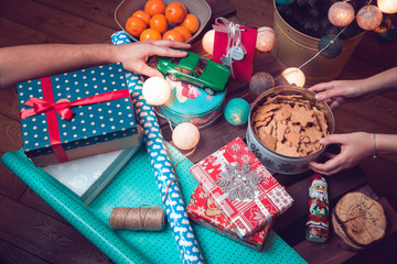 Christmas preparation. Gifts and sweets. Christmas tree lights and gingerbreads.