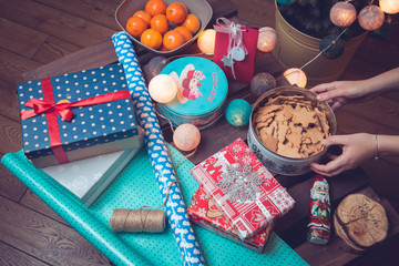 Christmas preparation. Gifts and sweets. Christmas tree lights and gingerbreads.