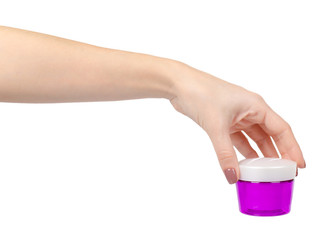 Face cream in plastic purple container. Isolated on white.