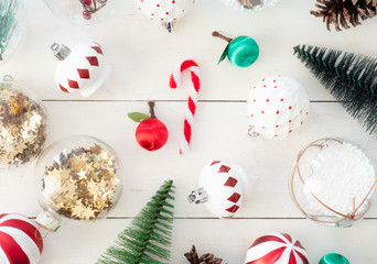 top view of Christmas and new year holidays concept with Pine cones, gift box, Christmas ball and Christmas decorations on white wooden background.
