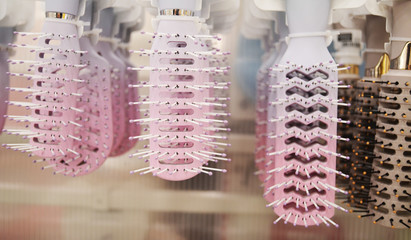 Pastel colored hair brushes close-up.