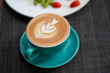 A cup of Coffee Latte on the table.