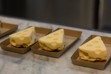 A slice of plain baked cheesecake isolated