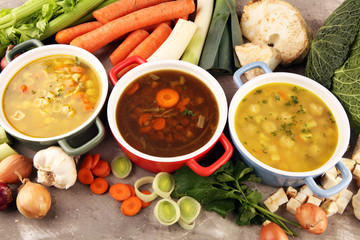 Set of soups from worldwide cuisines, healthy food. Broth with noodles, beef soup and broth with marrow dumplings. All soups with healthy vegetables on table