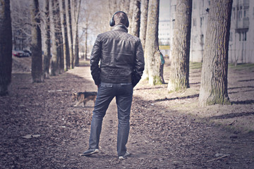 Obraz premium retro toned effected photo of alone man on street