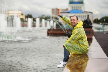 A man in a raincoat on a rainy day