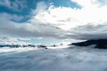 views of the mountains, clouds and fog below during a hot air balloon flight in La Cerdanya, Catalonia