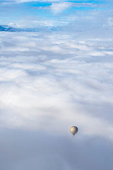 hot balloon between clouds in the area of Cerdanya, in Catalonia