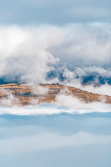 views of the mountains, clouds and fog below during a hot air balloon flight in La Cerdanya, Catalonia