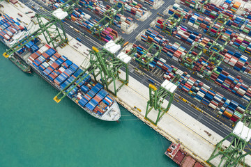 View from above, stunning aerial view of the port of Singapore with hundreds of colored containers...