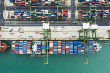 View from above, stunning aerial view of the port of Singapore with hundreds of colored containers...