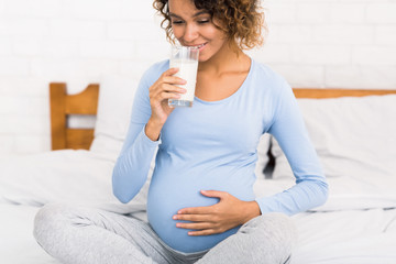 Obraz na płótnie Canvas Healthy breakfast for pregnant woman, enjoying milk