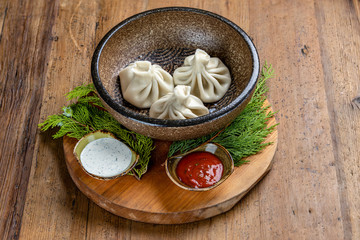 Georgian dish of khinkali from minced beef with tzahton sauce and adjika