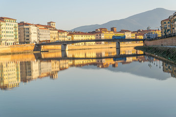 Sunset on the banks of the Arno River, Pisa, Italy.