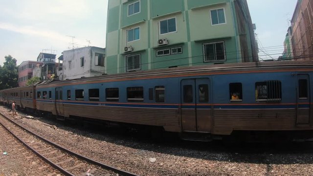 GoPro shot from a Thai Train Going Through the Suburbs of Bangkok and Passing an Idle Train
