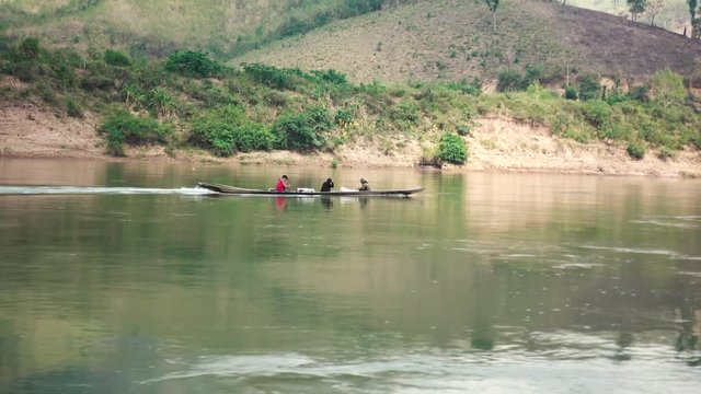 Three Local Laos People in a Fast Boat on the Mekong River