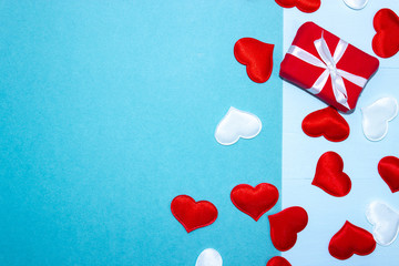 Happy Valentines Day. Background for Valentine's Day with red and white hearts and gifts. Happy Valentines Day. Congratulation on Valentine's Day on a blue background. Horizontal top view, flat lay.